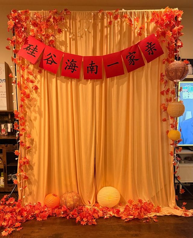 晚会拍照背景墙，挂着「硅谷海南一家亲」红色字幅